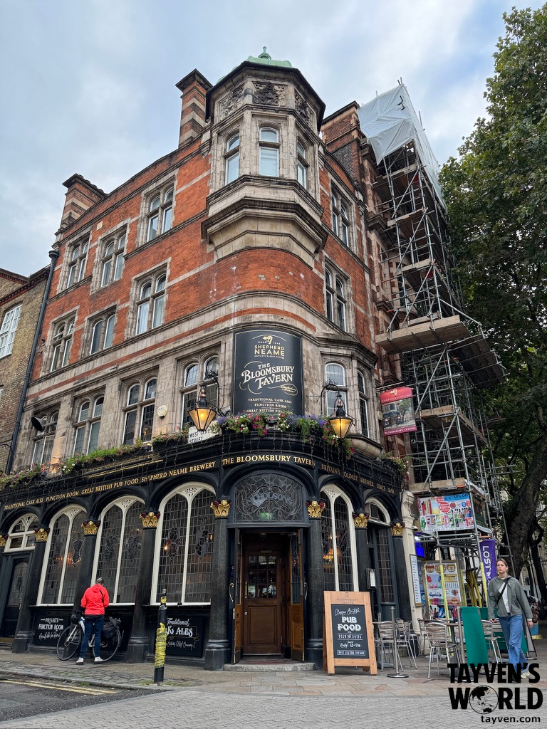 Exterior of The Bloomsbury Tavern, a traditional British pub with ornate brick architecture and hanging flowers in London.