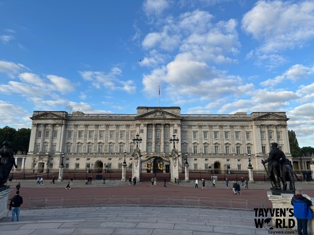 Front façade of Buckingham Palace with the main gates and forecourt visible.