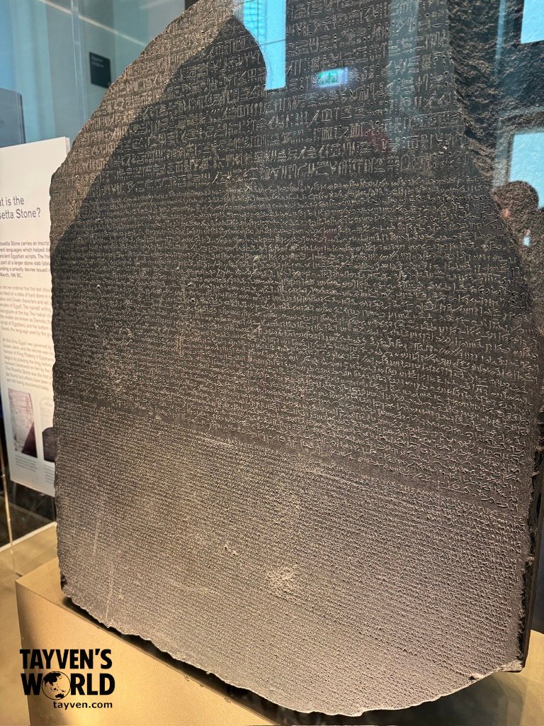 The Rosetta Stone Exhibit The Rosetta Stone displayed in a museum case, showing inscriptions in hieroglyphic, Demotic, and Greek scripts.