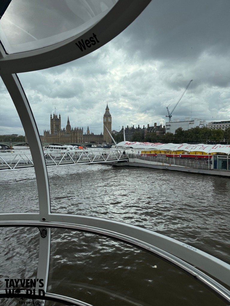 View of Big Ben and the Palace of Westminster from inside a London Eye capsule overlooking the Thames.