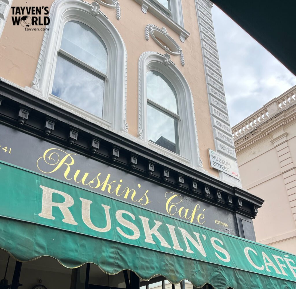 Ruskin’s Café, Museum Street, Bloomsbury Exterior of Ruskin’s Café on Museum Street in Bloomsbury, London, with ornate windows and green awning.