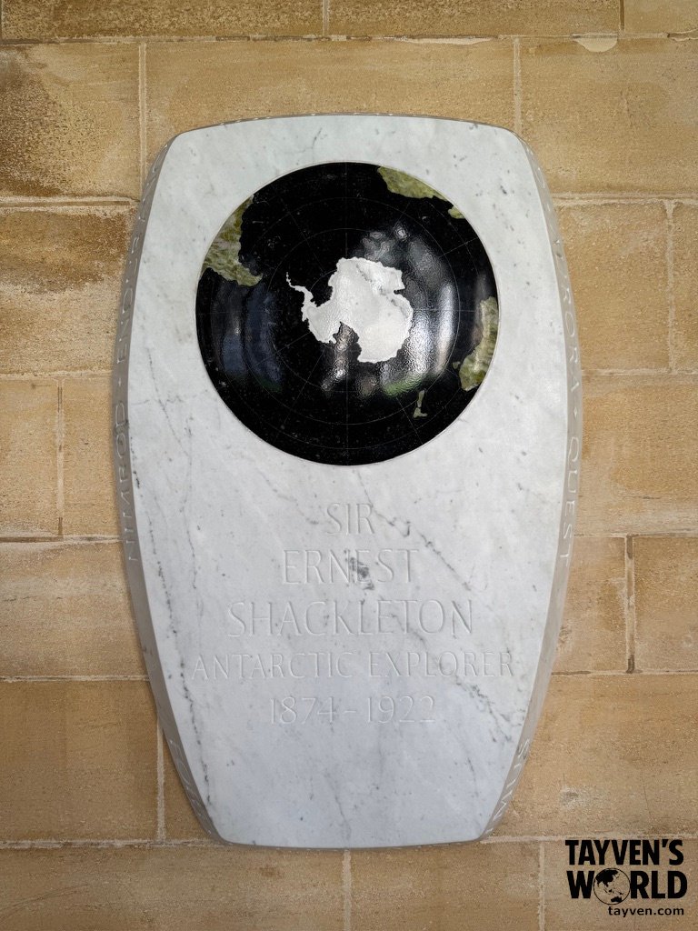 Marble memorial plaque for Sir Ernest Shackleton inside Westminster Abbey, featuring a circular map of Antarctica.
