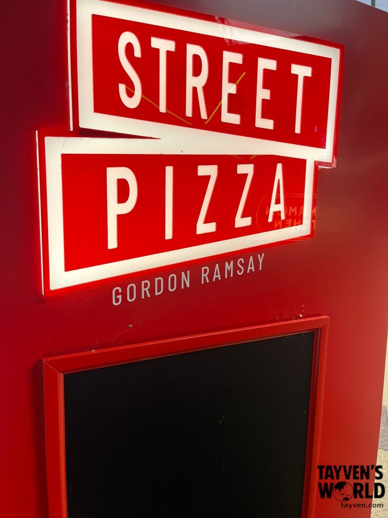 Bright red neon Street Pizza sign with Gordon Ramsay’s name beneath it.