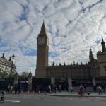 Big Ben and the Palace of Westminster with pedestrians and cyclists in the foreground.