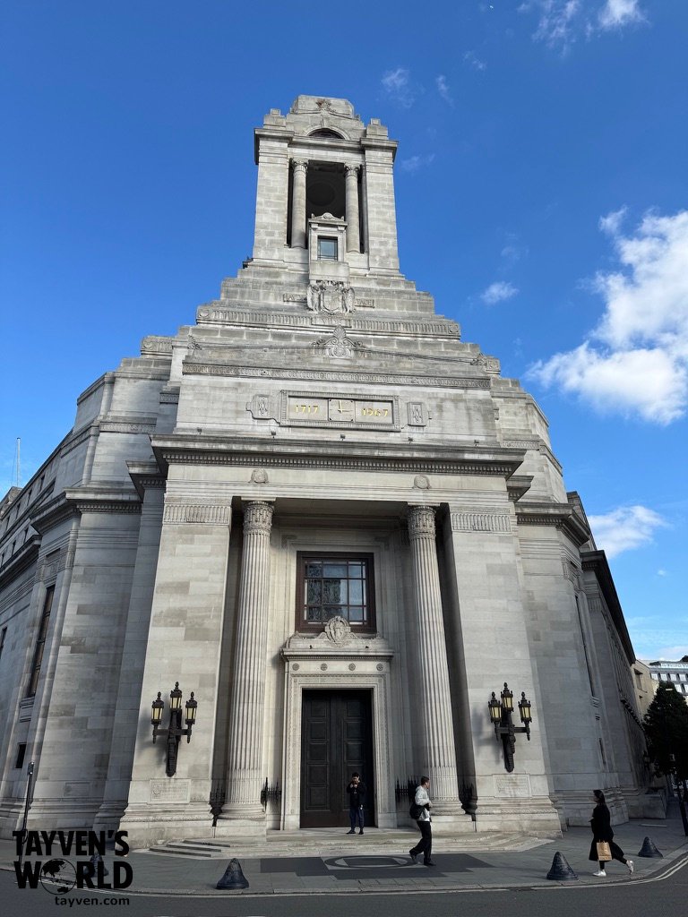 Freemasons’ Hall in London with its grand neoclassical façade under a clear blue sky.