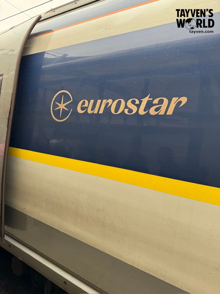 Side view of Eurostar train showing logo and yellow stripe at St Pancras International.