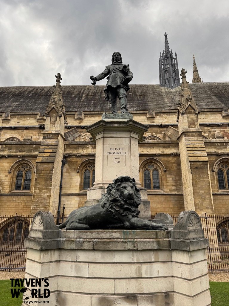Statue of Oliver Cromwell with a lion sculpture outside Westminster Palace.