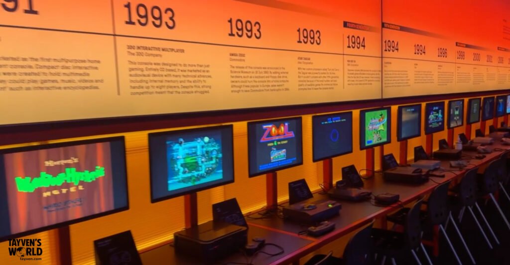Row of retro gaming consoles and monitors at the Power Up exhibition in London’s Science Museum, showing titles like Zool and Wacky Races.