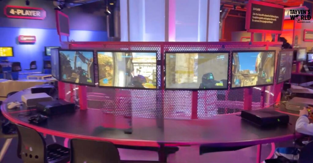 Visitors playing Halo multiplayer on linked Xbox consoles in the LAN arena at the Power Up exhibition.
