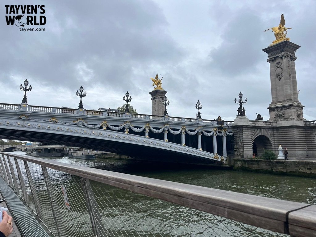 Ornate Pont Alexandre III bridge over the Seine with gilded statues and decorative lampposts.