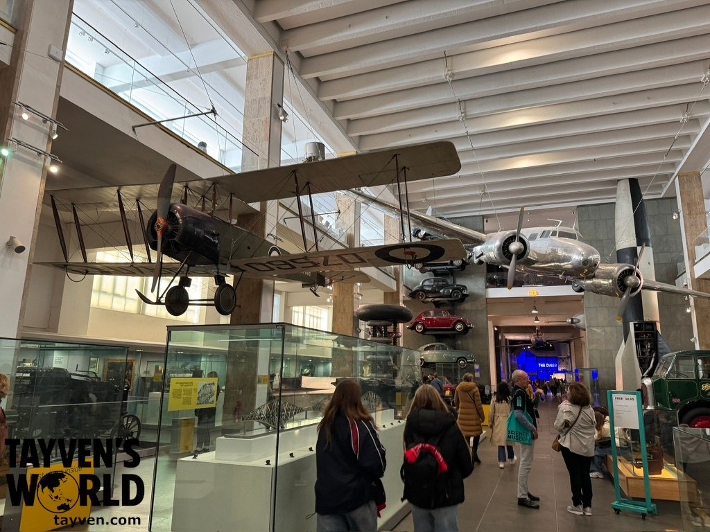 Visitors exploring the Science Museum’s aviation gallery in London, featuring suspended aircraft and engineering exhibits.