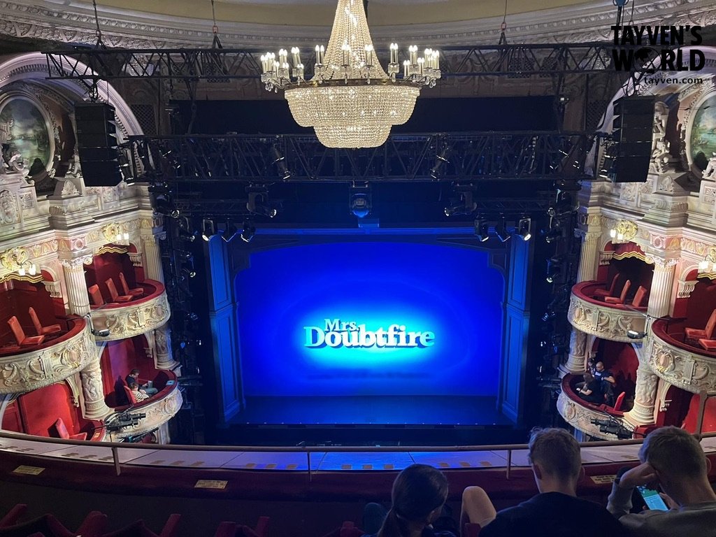 Interior of Shaftesbury Theatre with chandelier and stage showing “Mrs Doubtfire.”