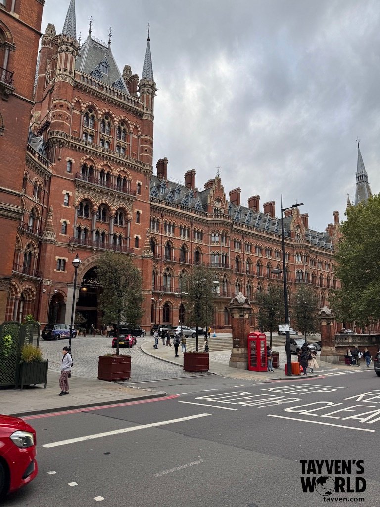 Gothic Revival architecture of St Pancras Renaissance Hotel in London with pedestrians and vehicles.
