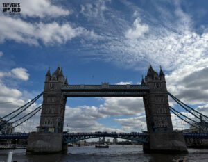 Wide view of Tower Bridge over the River Thames with reflections on the water.