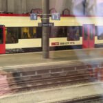 Swiss train at Basel SBB platform with signage and tracks in view.