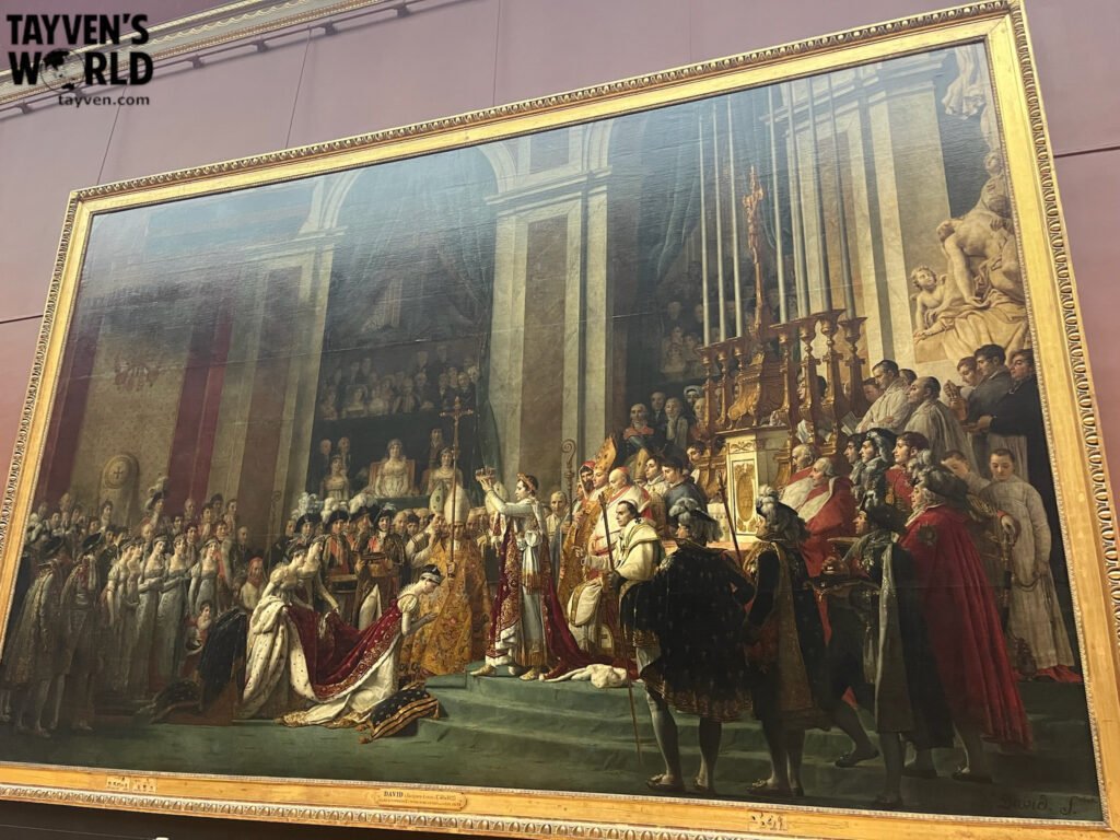 Large historical painting of Napoleon’s coronation displayed in the Louvre Museum.