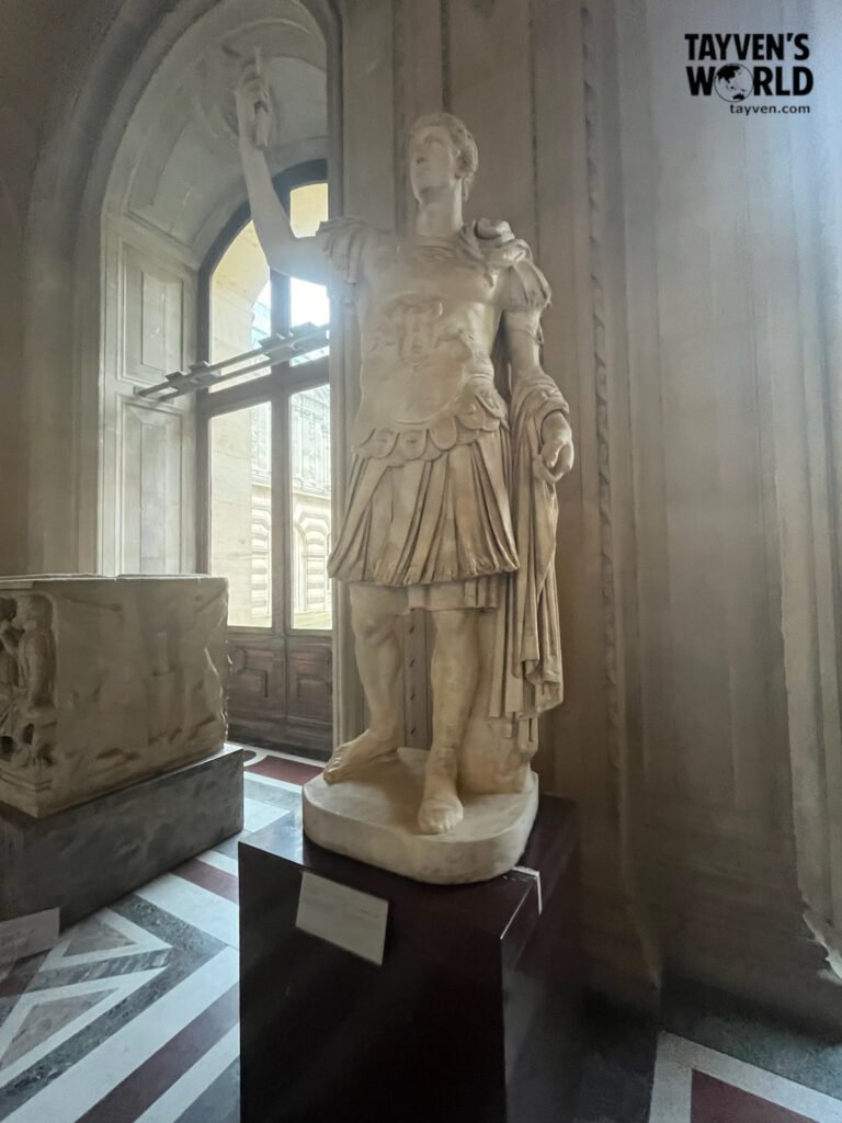 Marble statue of Emperor Augustus displayed in the Louvre Museum.