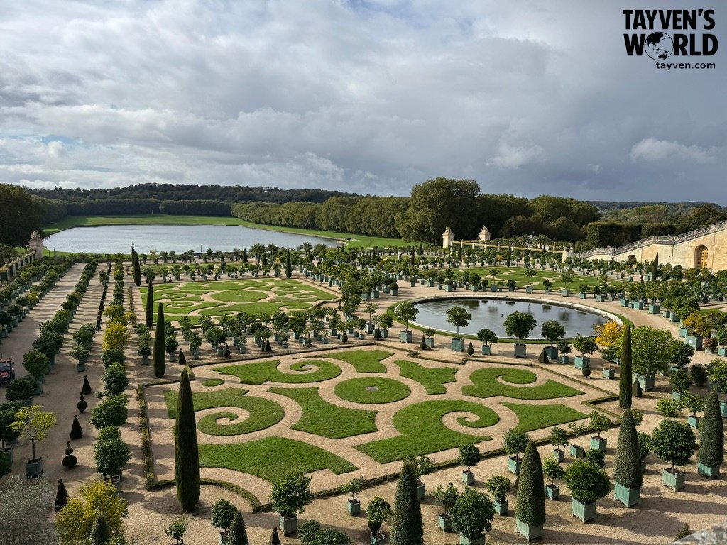 Ornate geometric gardens and ponds at the Palace of Versailles.