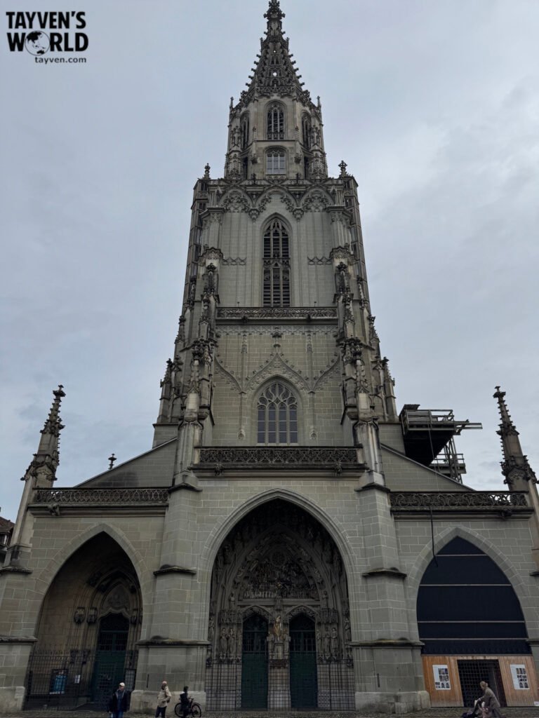 Gothic cathedral tower of Bern Minster viewed from street level