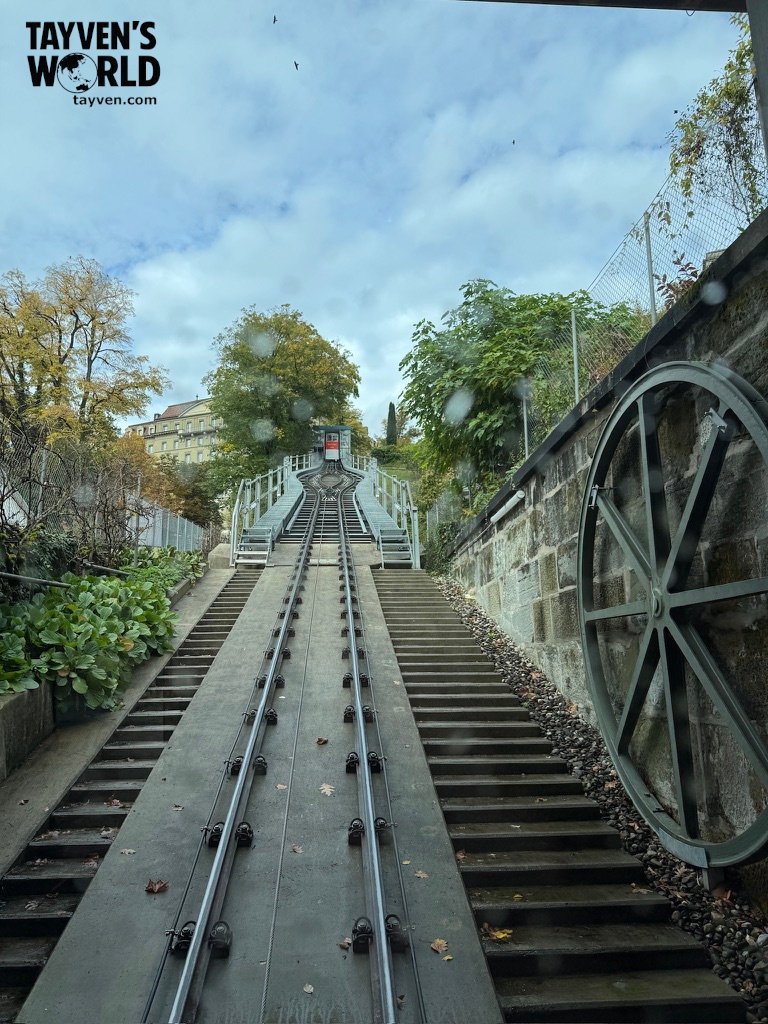 View up the tracks of Bern’s funicular railway with red car at the top