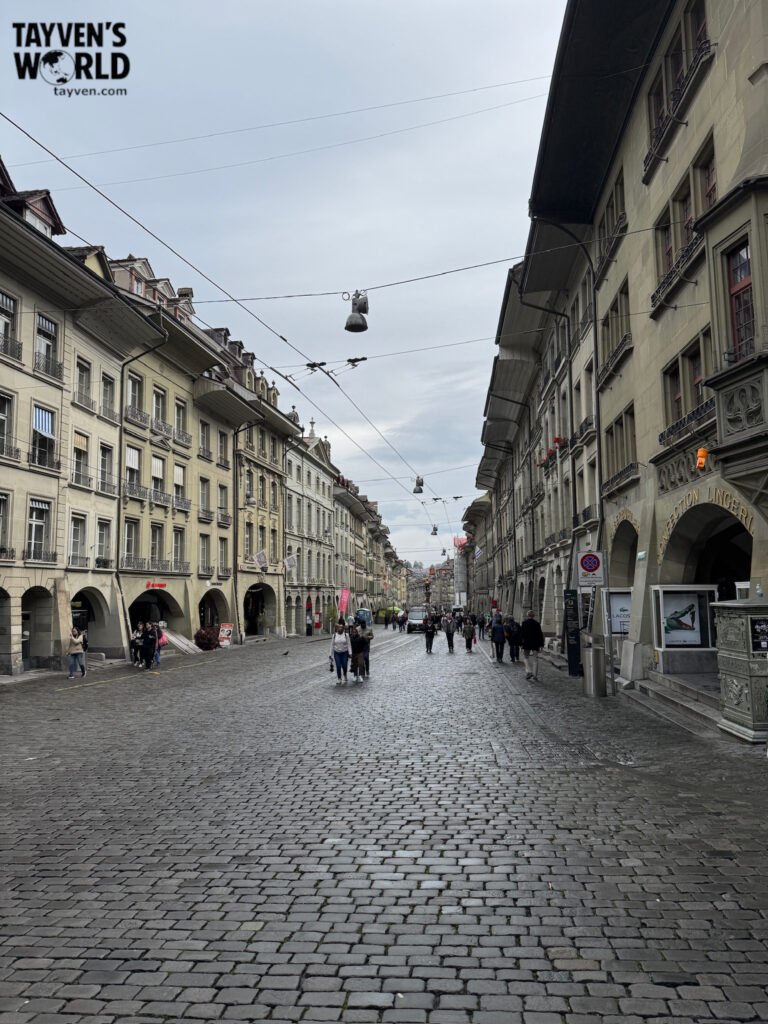 Cobblestone street in Bern’s old town with pedestrians and historic buildings