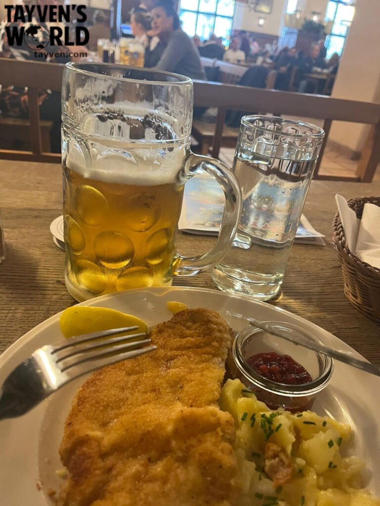 Pork schnitzel, potato salad and a large Hofbräu beer inside Munich’s Hofbräuhaus Title: Schnitzel and Beer at the Hofbräuhaus Munich