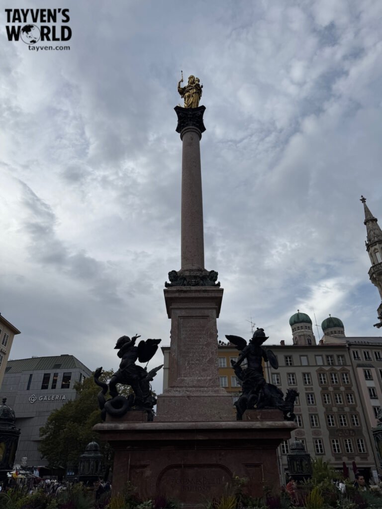 Mariensäule column in Marienplatz with the Frauenkirche towers behind it