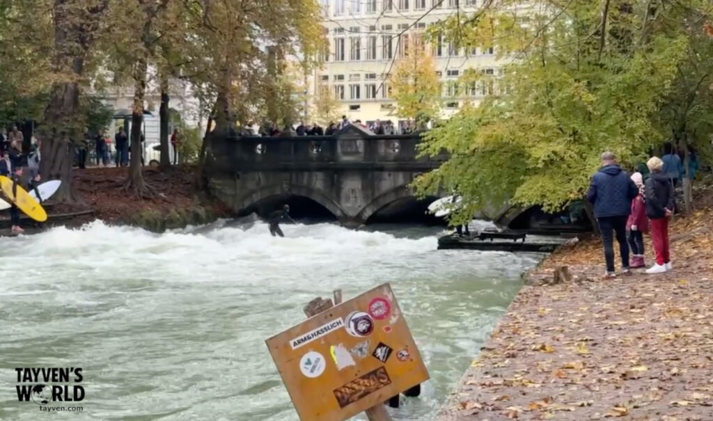 River surfer riding the Eisbach wave in Munich’s English Garden