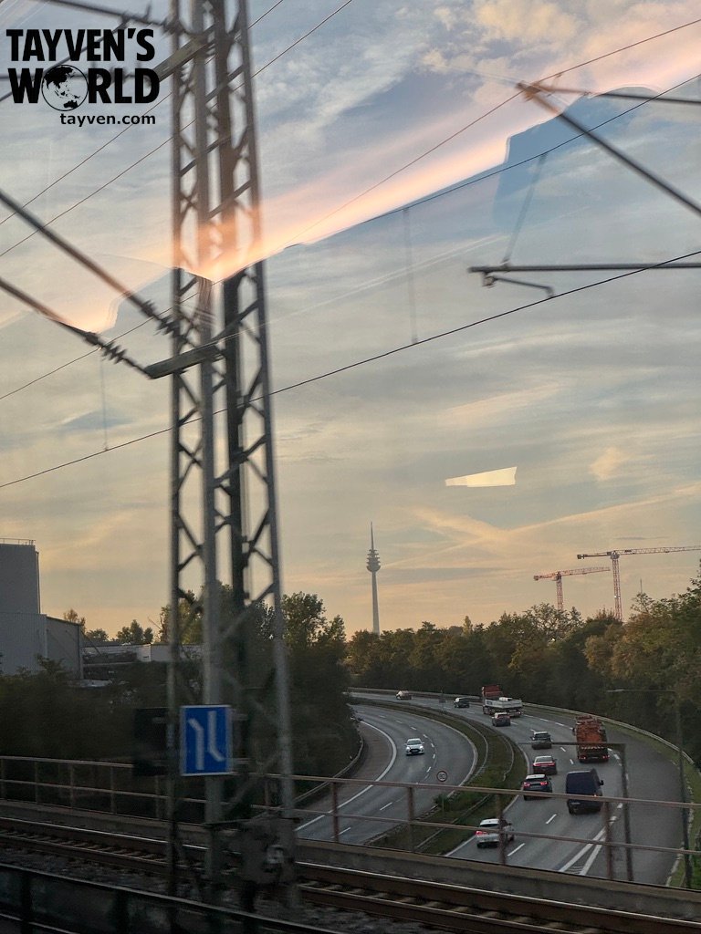 Telecommunications tower, highway and railway infrastructure seen from a train near Nuremberg