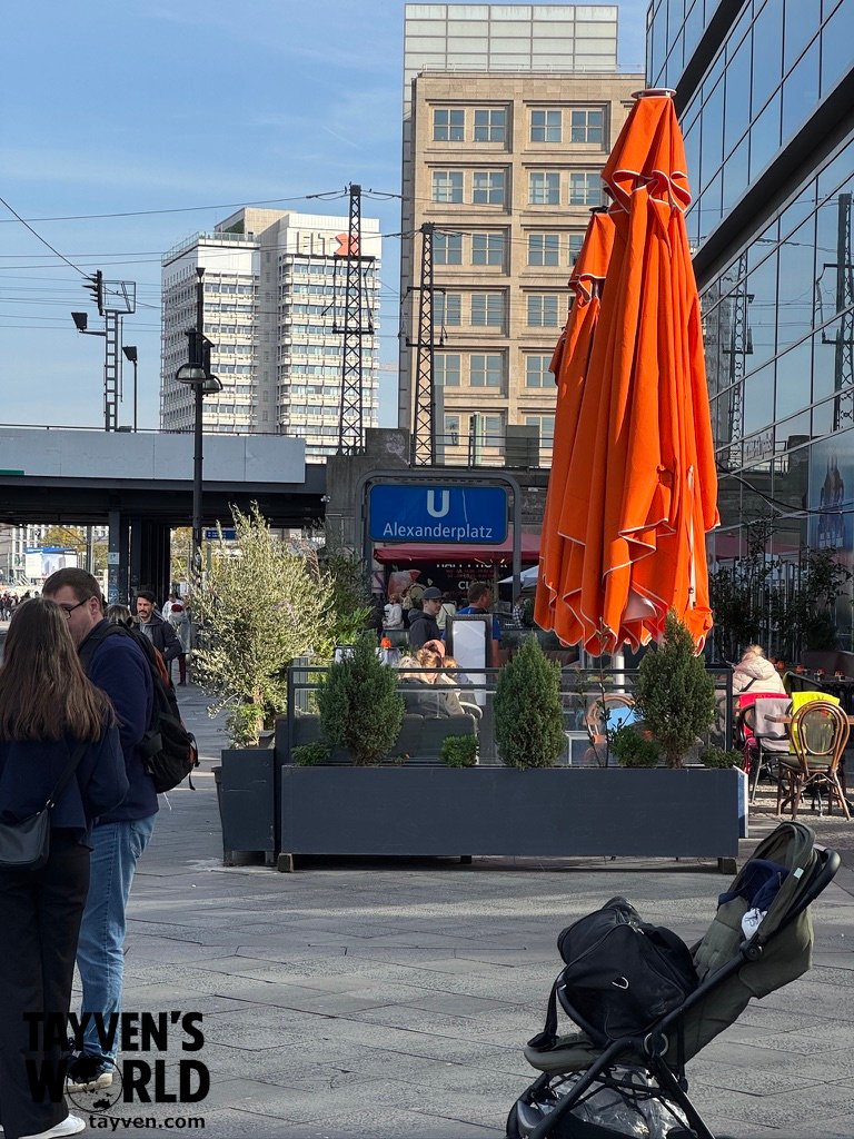 Alexanderplatz U-Bahn entrance beside outdoor seating and modern buildings in central Berlin