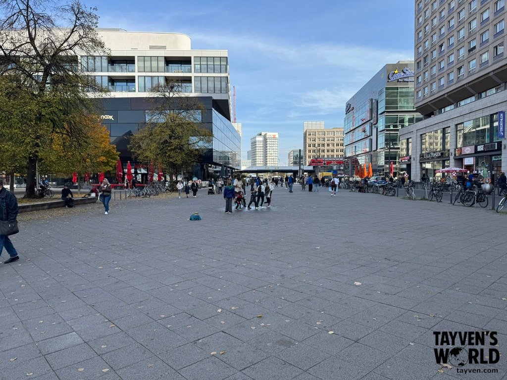 Wide pedestrian plaza with shops, bicycles and modern buildings at Alexanderplatz in Berlin