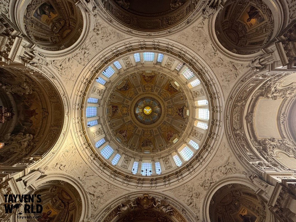 Interior dome ceiling of Berlin Cathedral showing ornate artwork, sculptures and detailed architectural decoration