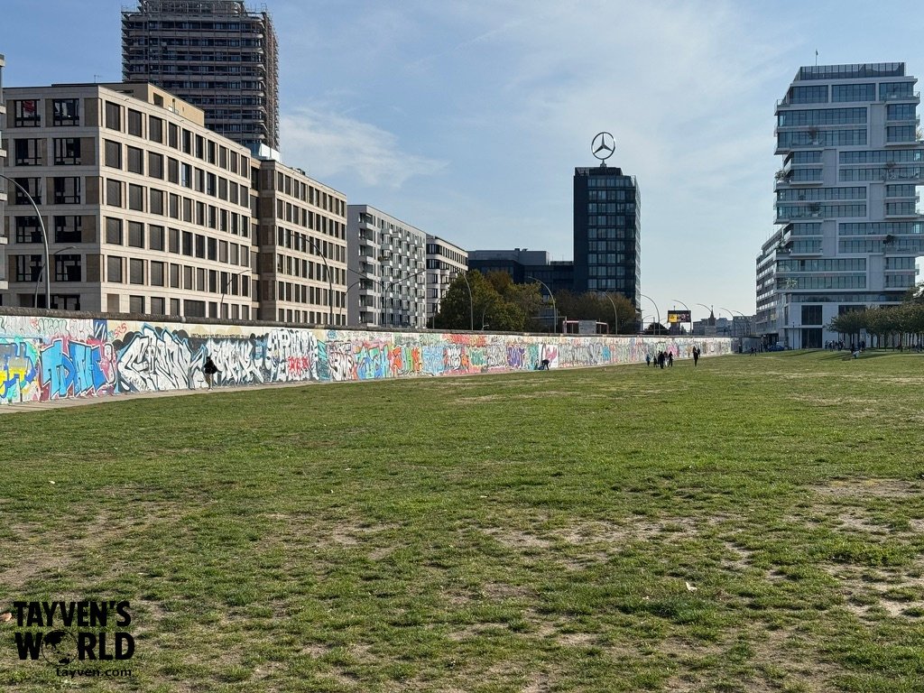 Long section of the East Side Gallery Berlin Wall covered in graffiti and artwork